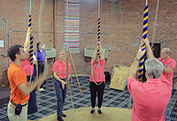 Bell ringers stand in a circle to ring the bells